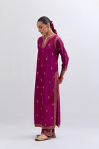 Fuchsia Silk Chanderi straight kurta set with narrow border dull gold dori embroidery at front & back neck, sleeves, side slits and hem, highlighted with gold sequins and bead work.