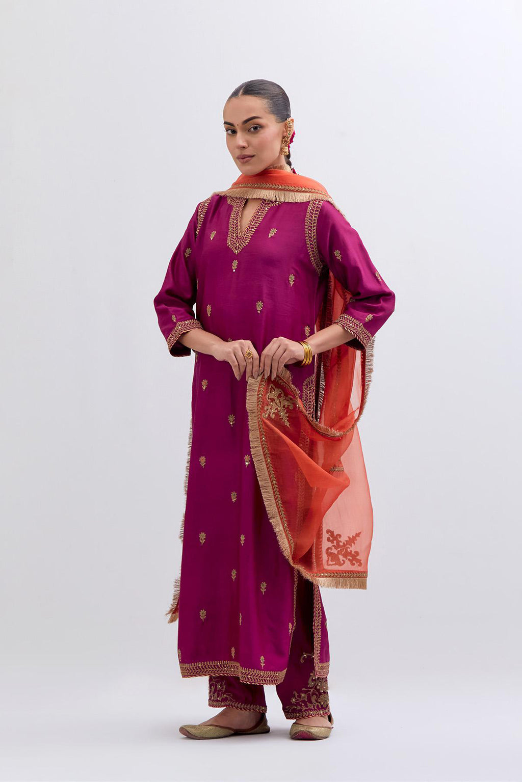 Fuchsia Silk Chanderi straight kurta set with narrow border dull gold dori embroidery at front & back neck, sleeves, side slits and hem, highlighted with gold sequins and bead work.