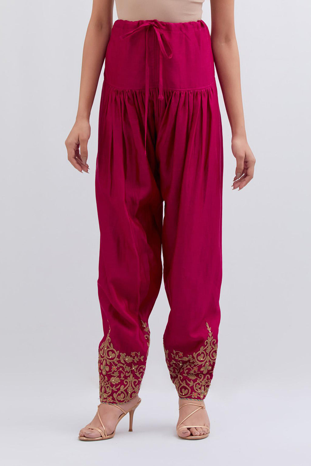Fuchsia Silk Chanderi narrow salwar with light gold dori embroidery at hem, highlighted with multi colored beads and gold sequins work.
