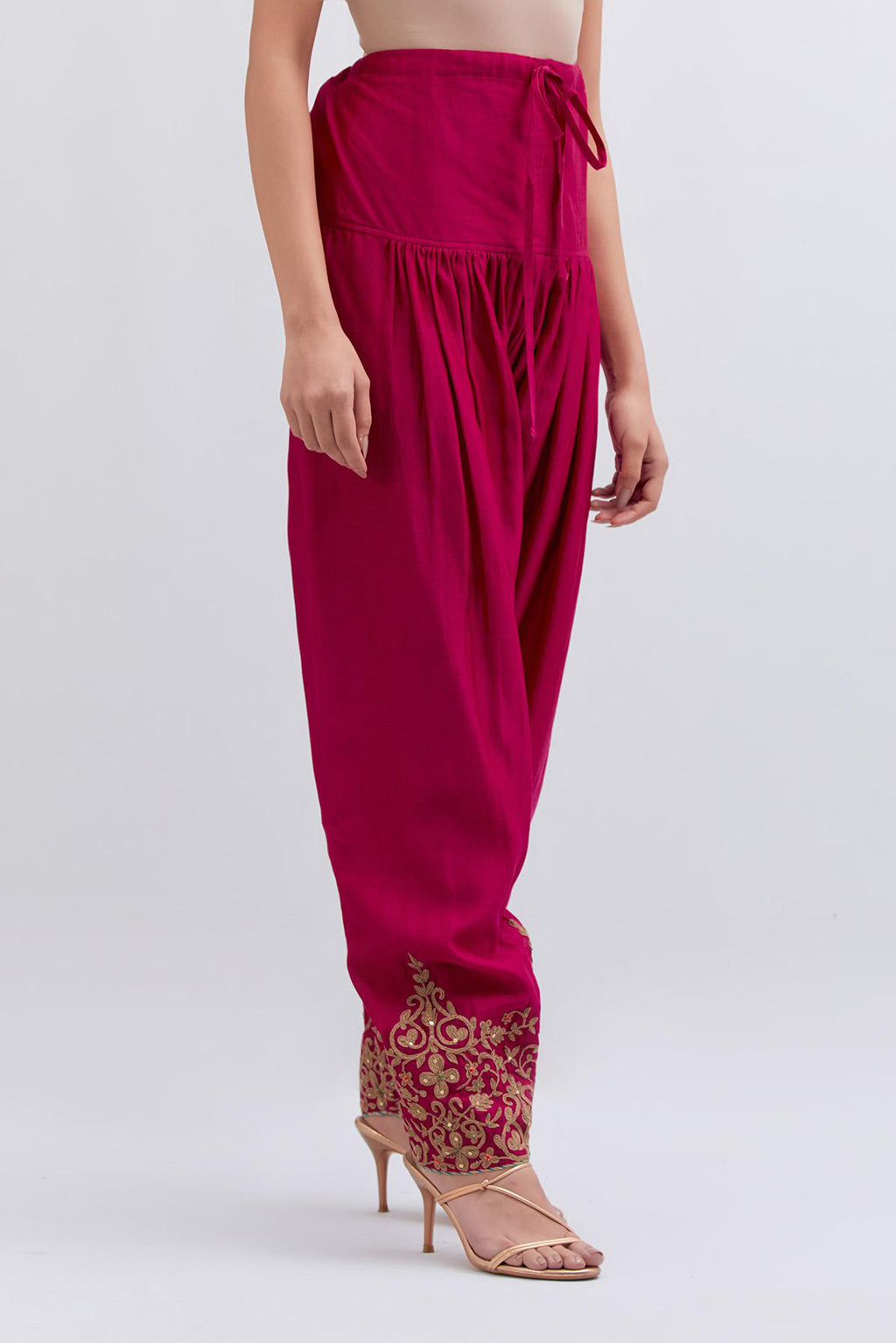 Fuchsia Silk Chanderi narrow salwar with light gold dori embroidery at hem, highlighted with multi colored beads and gold sequins work.