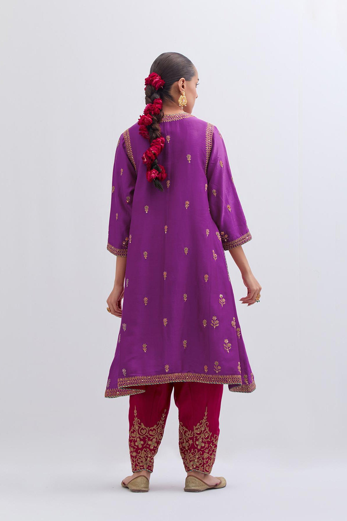 Purple Silk Chanderi A-line short kurta set with dull gold dori embroidery at neck, 3/4 sleeves, pockets and hem, highlighted with multi colored beads and gold sequins work.