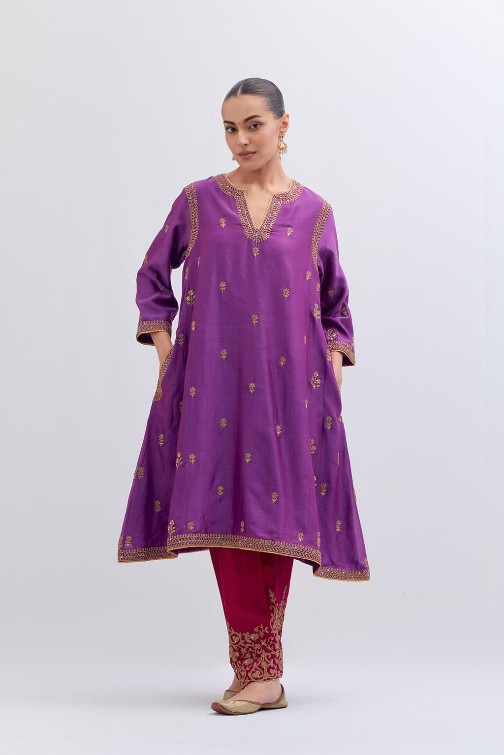 Purple Silk Chanderi A-line short kurta set with dull gold dori embroidery at neck, 3/4 sleeves, pockets and hem, highlighted with multi colored beads and gold sequins work.