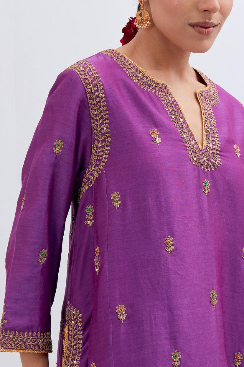 Purple Silk Chanderi A-line short kurta set with dull gold dori embroidery at neck, 3/4 sleeves, pockets and hem, highlighted with multi colored beads and gold sequins work.
