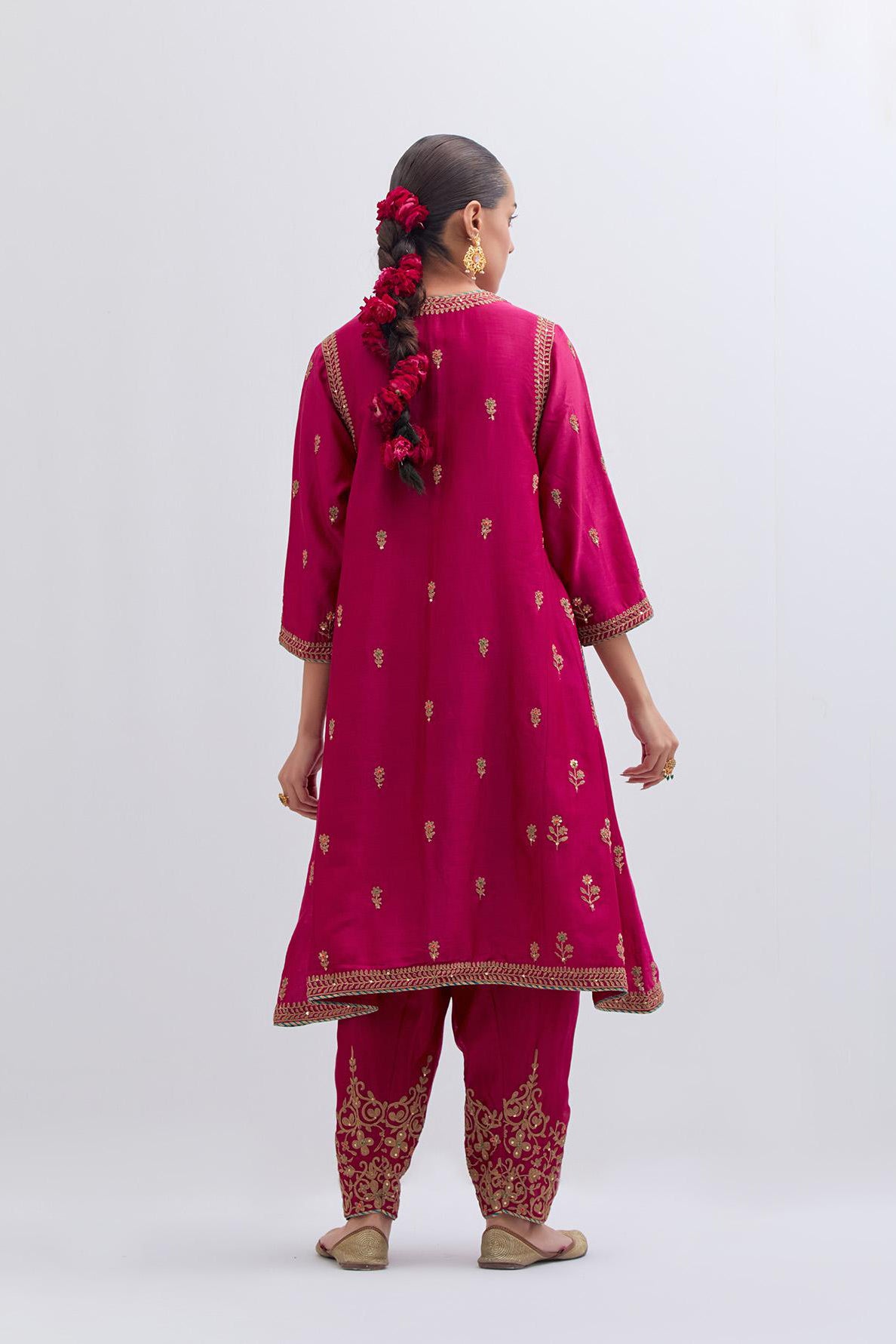 Fuchsia Silk Chanderi A-line short kurta set with dull gold dori embroidery at neck, 3/4 sleeves, pockets and hem, highlighted with multi colored beads and gold sequins work.