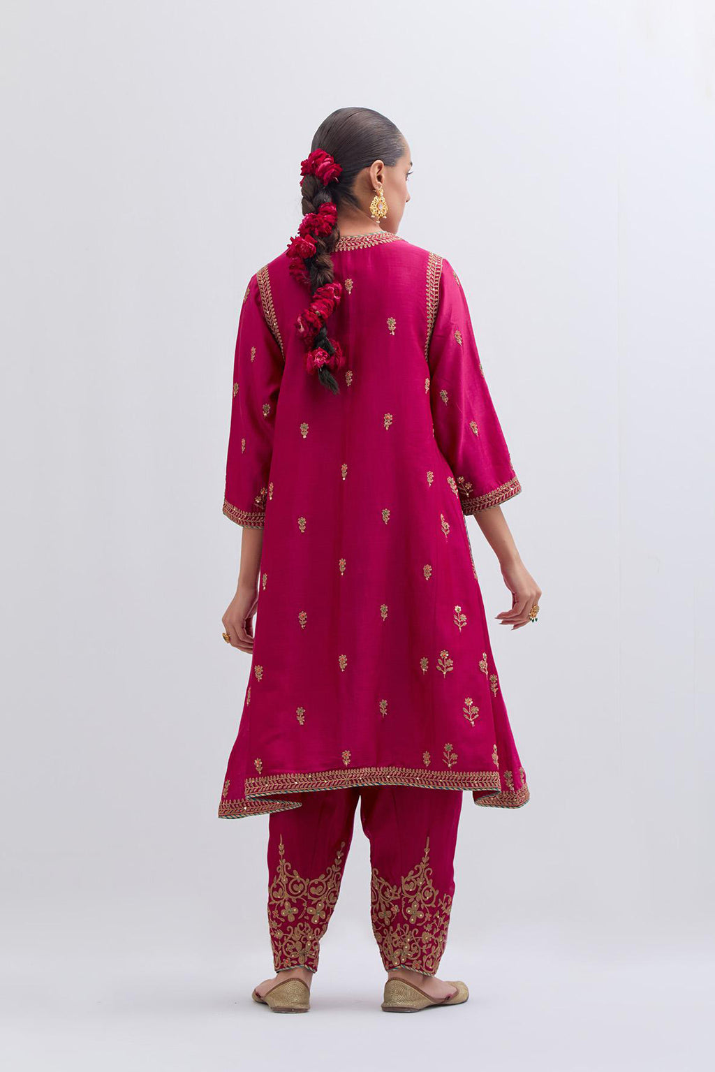 Fuchsia Silk Chanderi A-line short kurta set with dull gold dori embroidery at neck, 3/4 sleeves, pockets and hem, highlighted with multi colored beads and gold sequins work.