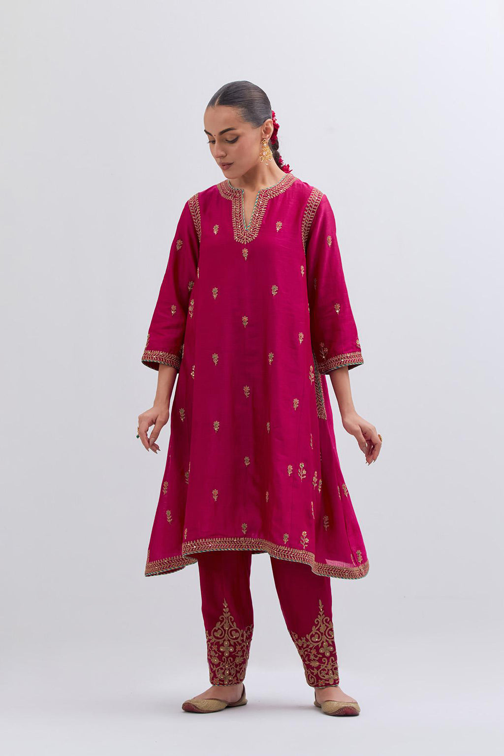 Fuchsia Silk Chanderi A-line short kurta set with dull gold dori embroidery at neck, 3/4 sleeves, pockets and hem, highlighted with multi colored beads and gold sequins work.