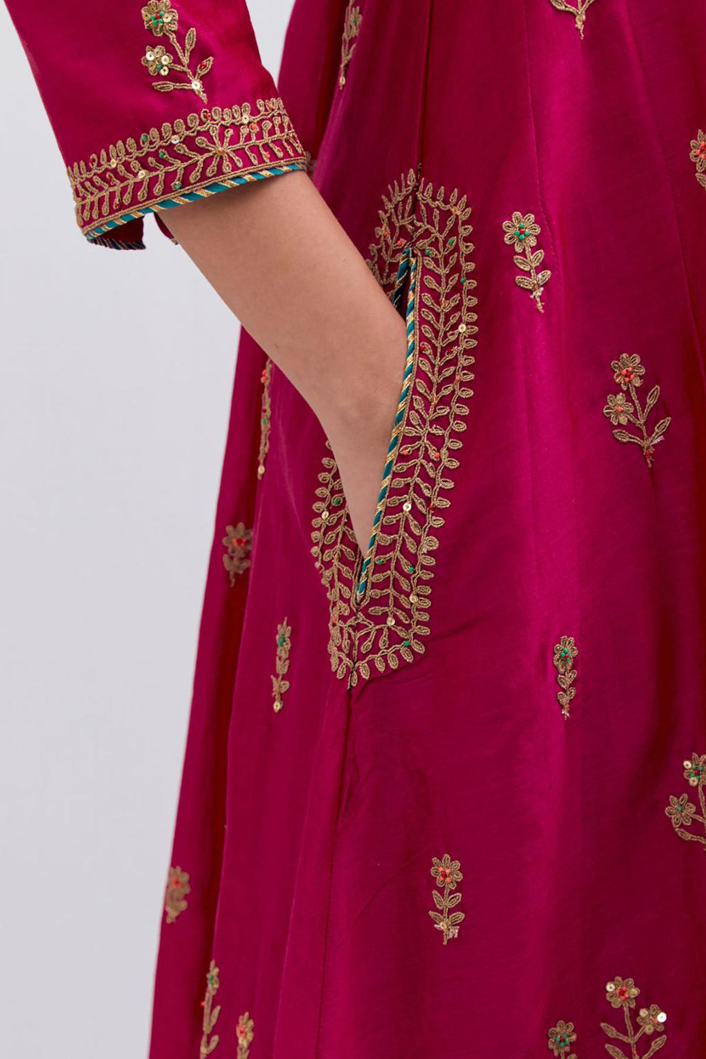 Fuchsia Silk Chanderi A-line short kurta set with dull gold dori embroidery at neck, 3/4 sleeves, pockets and hem, highlighted with multi colored beads and gold sequins work.
