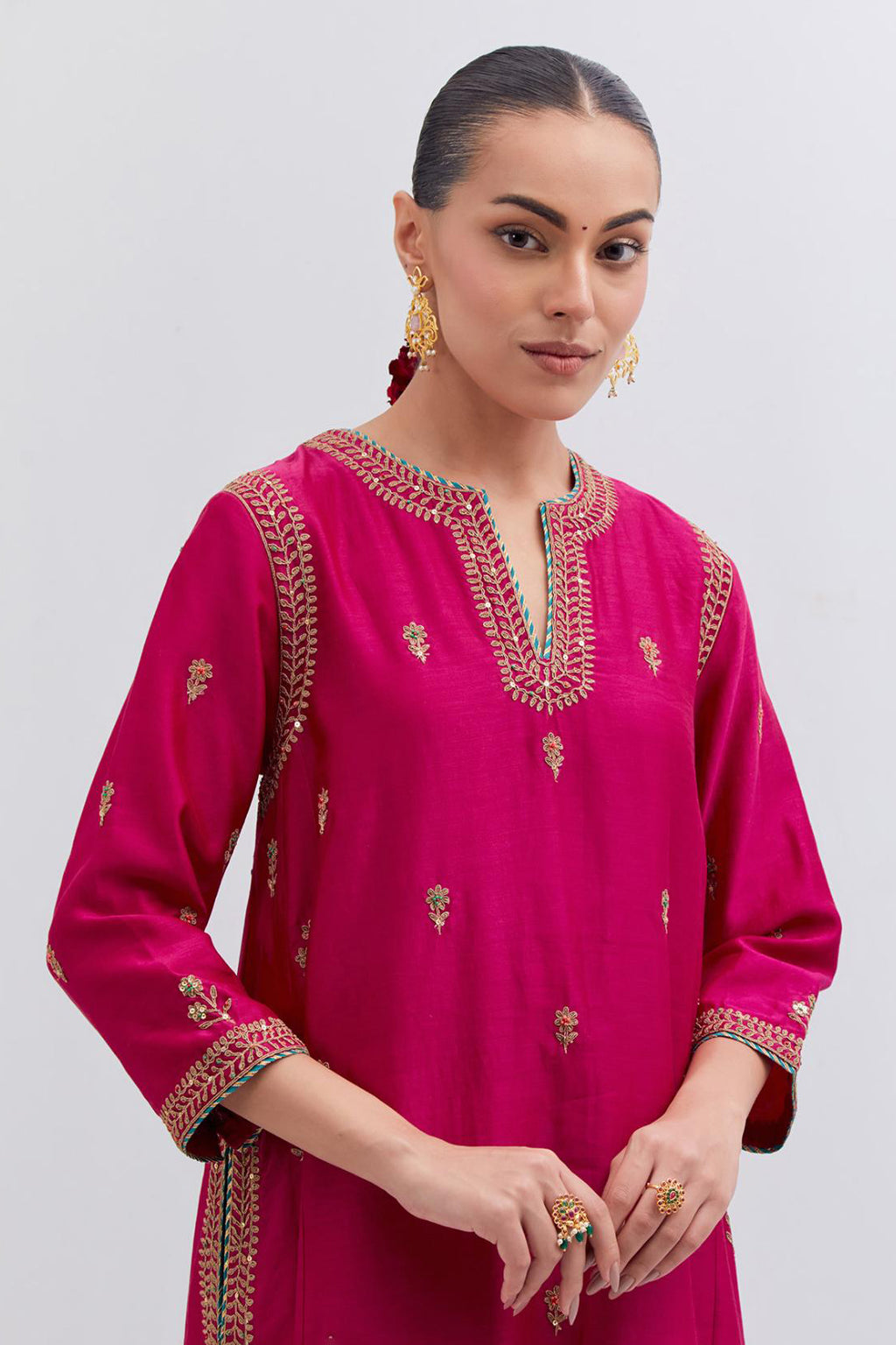 Fuchsia Silk Chanderi A-line short kurta set with dull gold dori embroidery at neck, 3/4 sleeves, pockets and hem, highlighted with multi colored beads and gold sequins work.