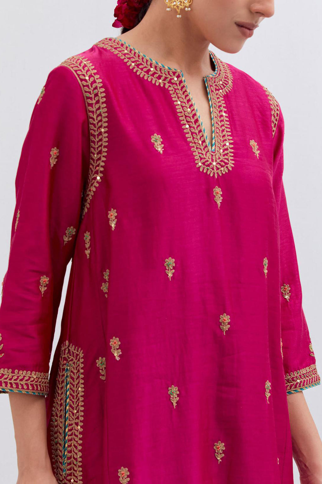 Fuchsia Silk Chanderi A-line short kurta set with dull gold dori embroidery at neck, 3/4 sleeves, pockets and hem, highlighted with multi colored beads and gold sequins work.