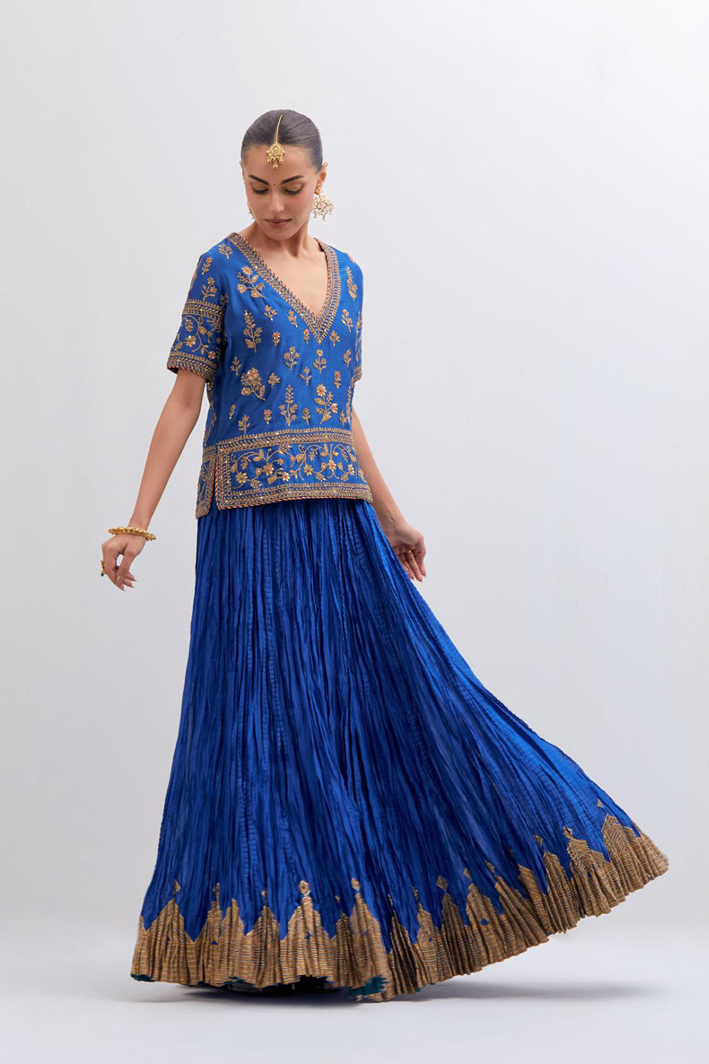 Chelsea Blue Silk Chanderi long choli set with all-over dull gold dori embroidery, highlighted with multi colored beads and gold sequins work.