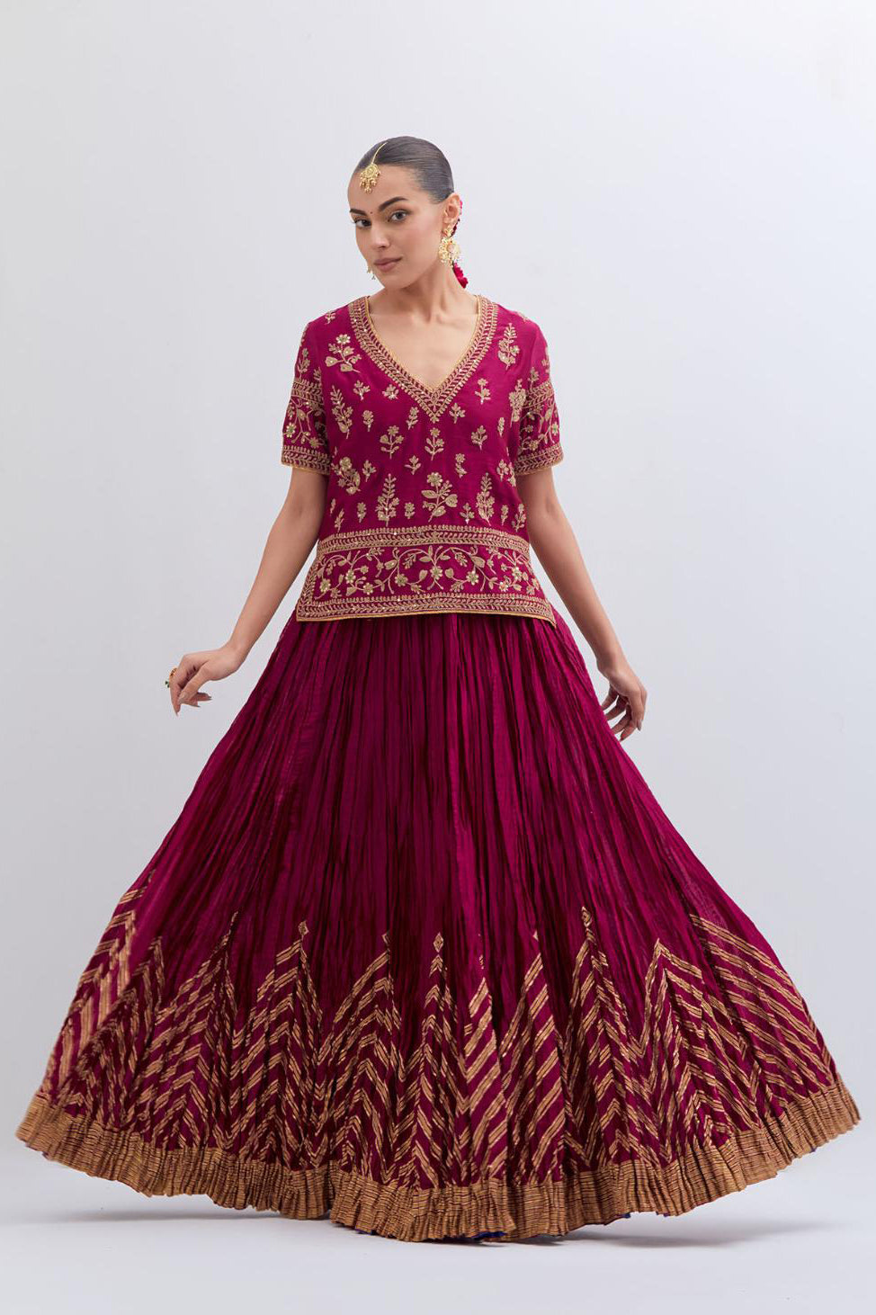 Deep Fuchsia Silk Chanderi long choli set with all-over dull gold dori embroidery, highlighted with multi colored beads and gold sequins work.