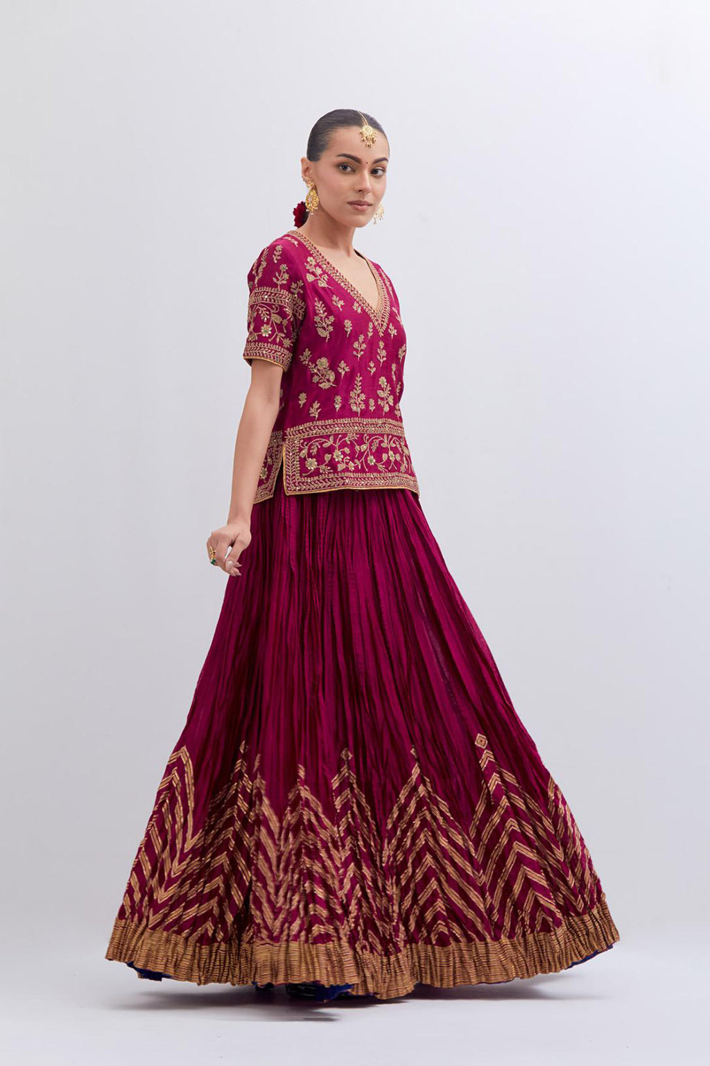 Deep Fuchsia Silk Chanderi long choli set with all-over dull gold dori embroidery, highlighted with multi colored beads and gold sequins work.