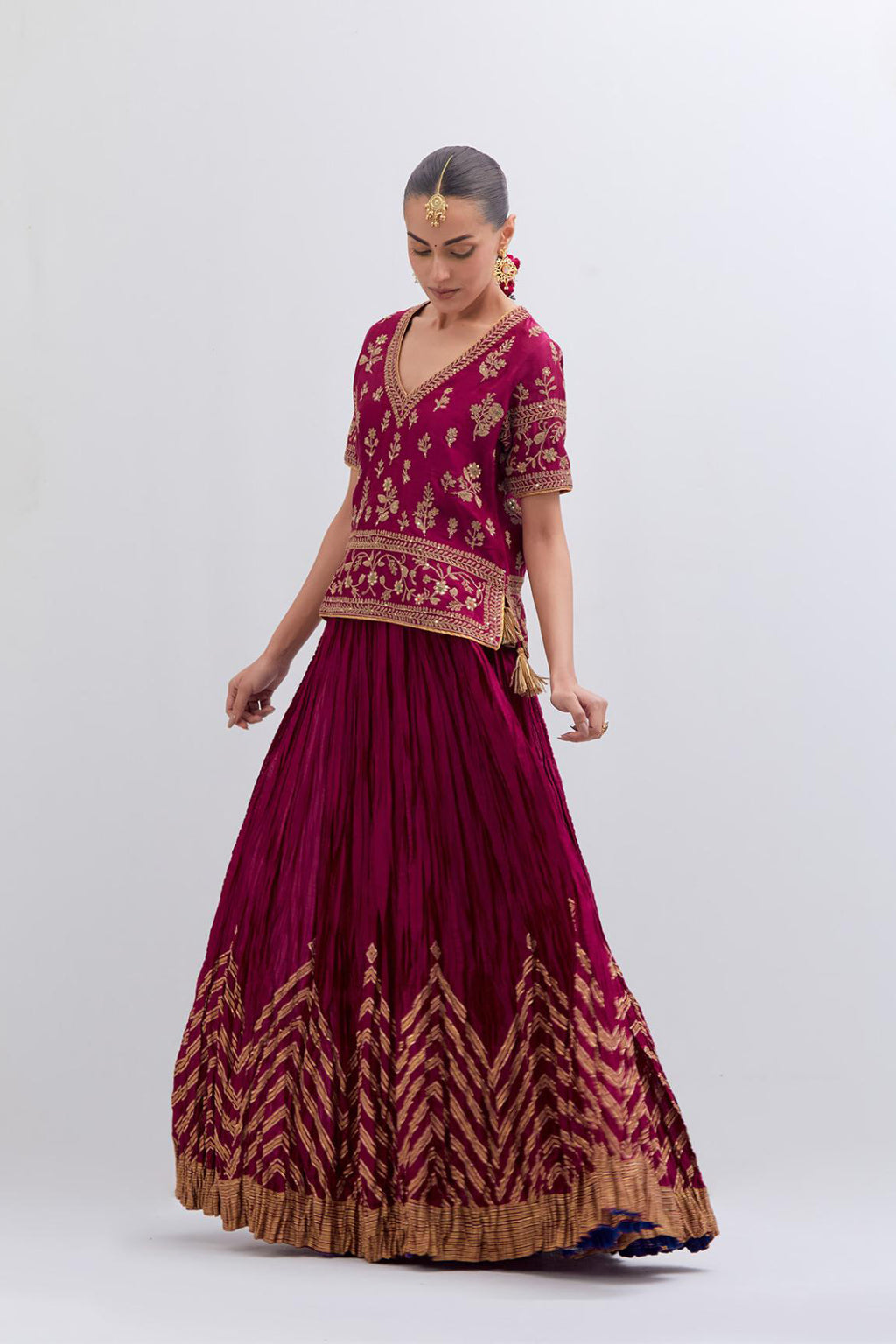 Deep Fuchsia Silk Chanderi long choli set with all-over dull gold dori embroidery, highlighted with multi colored beads and gold sequins work.
