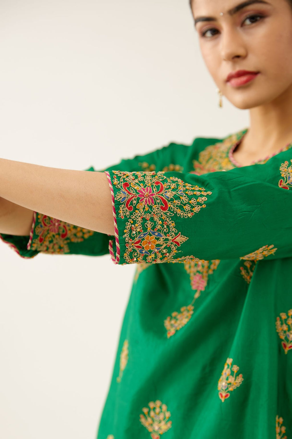 Green silk short kurta set, with dori & silk thread embroidery highlighted with contrast bead & sequins work.