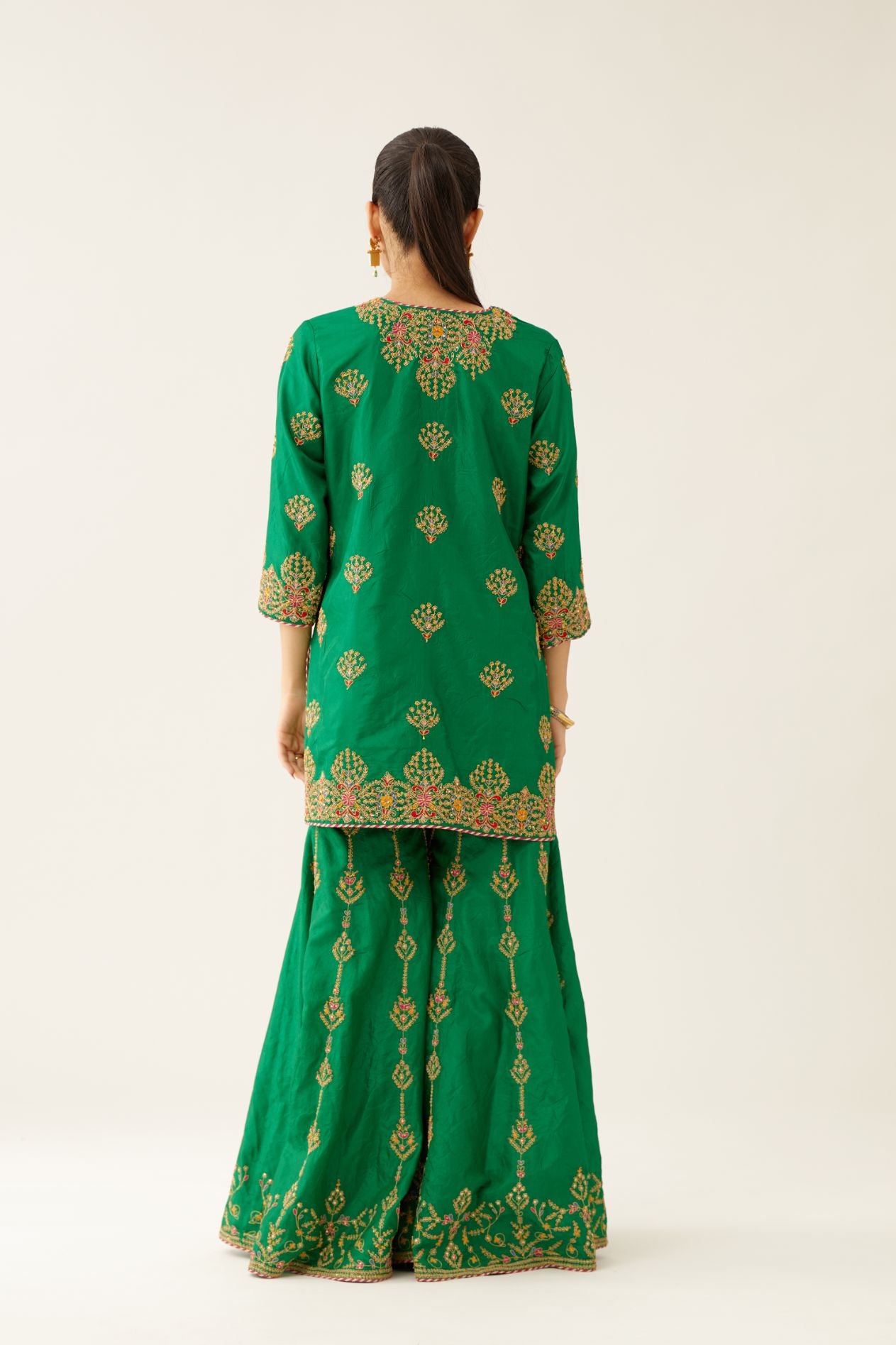 Green silk short kurta set, with dori & silk thread embroidery highlighted with contrast bead & sequins work.