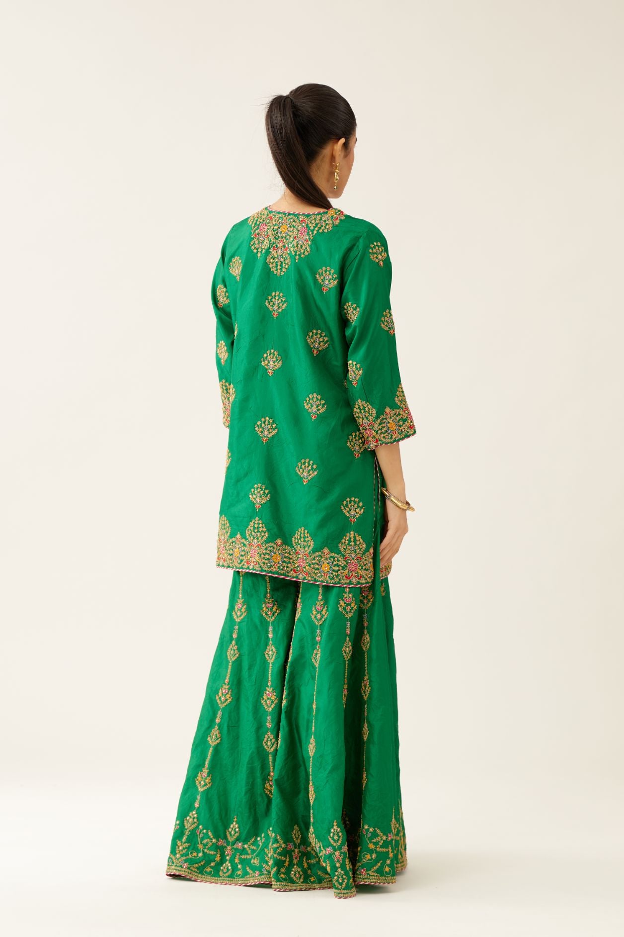 Green silk short kurta set, with dori & silk thread embroidery highlighted with contrast bead & sequins work.