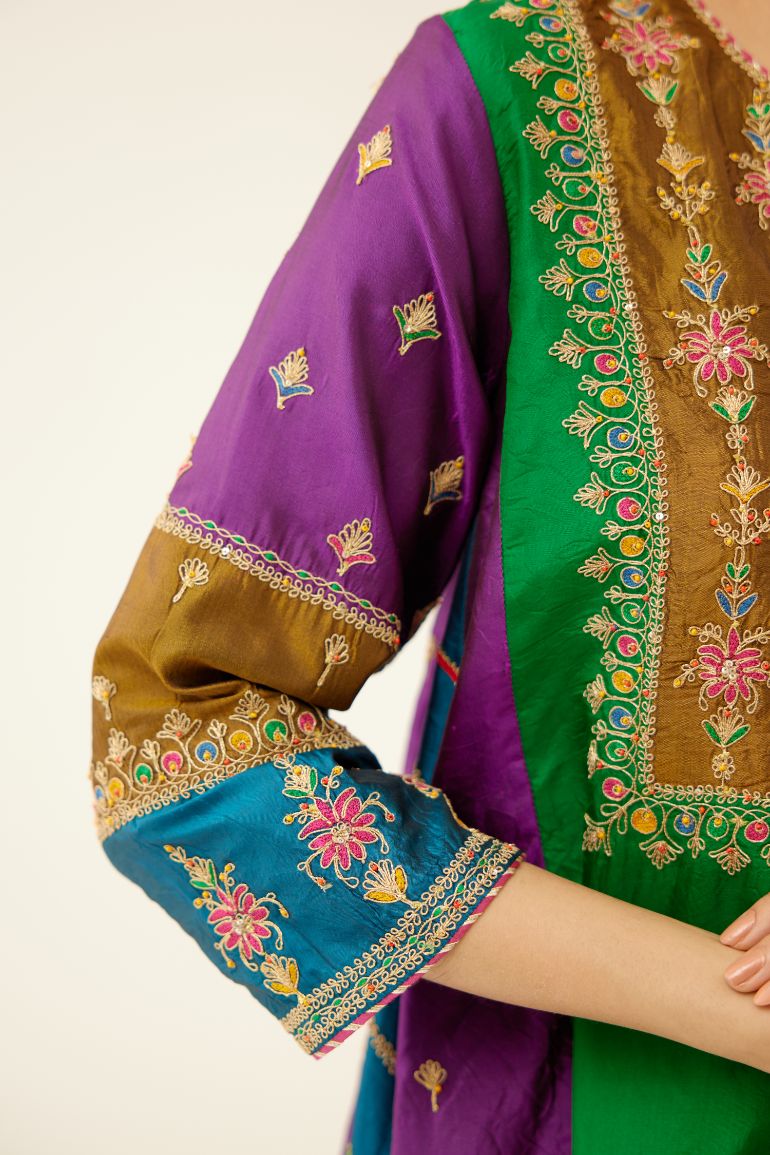 Color blocked multi panelled silk kurta dress set with asymmetric hem, highlighted with all over delicate dori & silk thread embroidery.