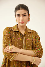 Golden olive A-line short silk kurta set with all over embroidery, highlighted with sequins and bead work, paired with golden olive silk straight pants with dori and silk thread embroidery.