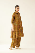 Golden olive A-line short silk kurta set with all over embroidery, highlighted with sequins and bead work, paired with golden olive silk straight pants with dori and silk thread embroidery.