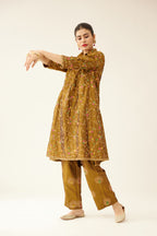 Golden olive A-line short silk kurta set with all over embroidery, highlighted with sequins and bead work, paired with golden olive silk straight pants with dori and silk thread embroidery.