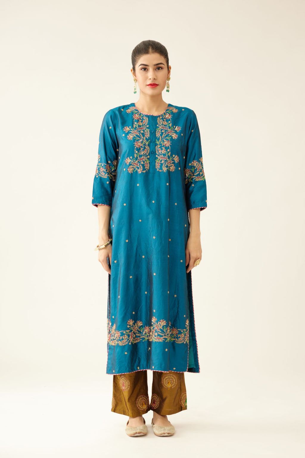 Dark teal straight silk kurta set, highlighted with delicate dori and thread embroidery detailed with contrasting bead and sequins work.
