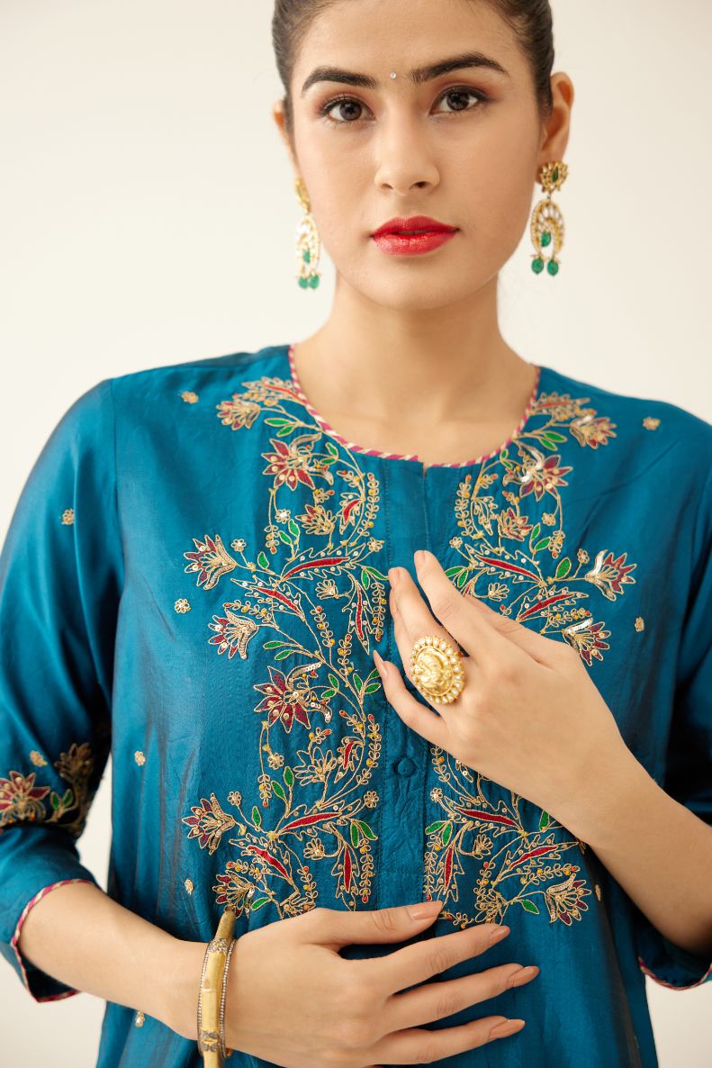 Dark teal straight silk kurta set, highlighted with delicate dori and thread embroidery detailed with contrasting bead and sequins work.