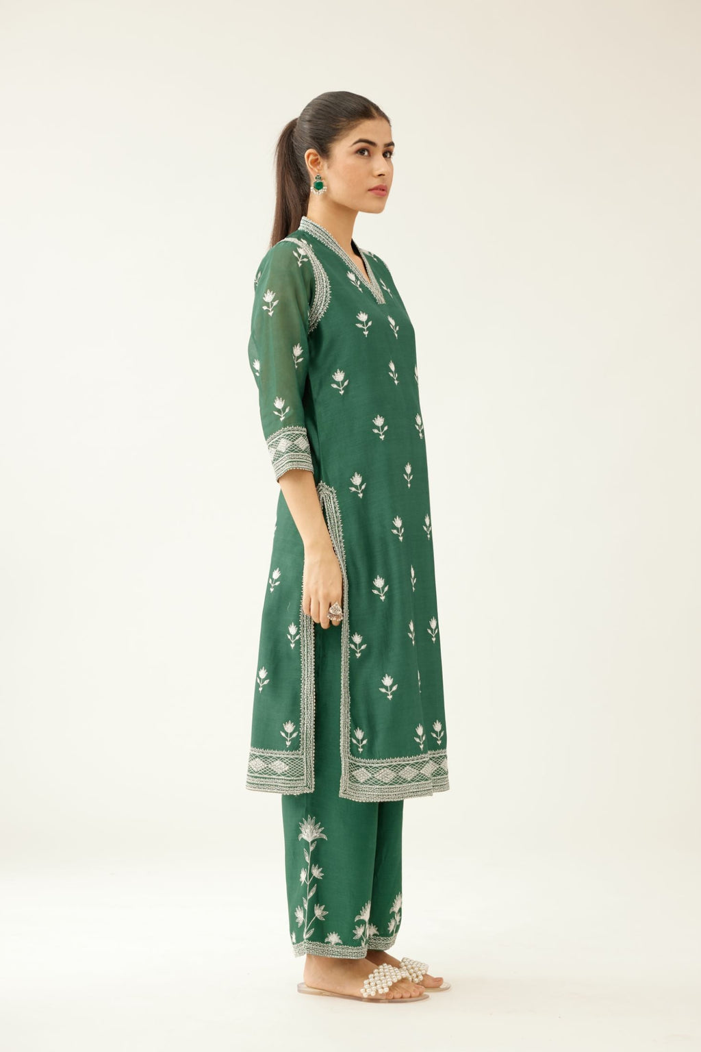 Green silk chanderi mid length straight kurta set with all over off white silk thread embroidery.
