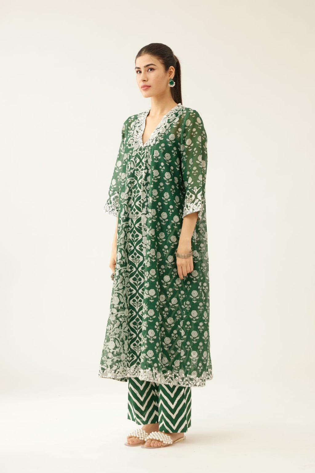 Green hand block printed kurta dress set with a V neck, detailed with sequin, tassels and bead work.