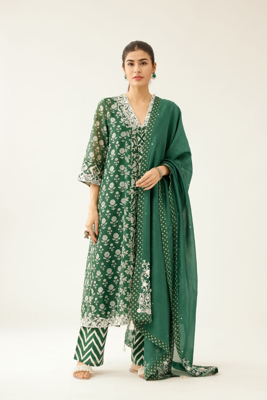 Green hand block printed kurta dress set with a V neck, detailed with sequin, tassels and bead work.