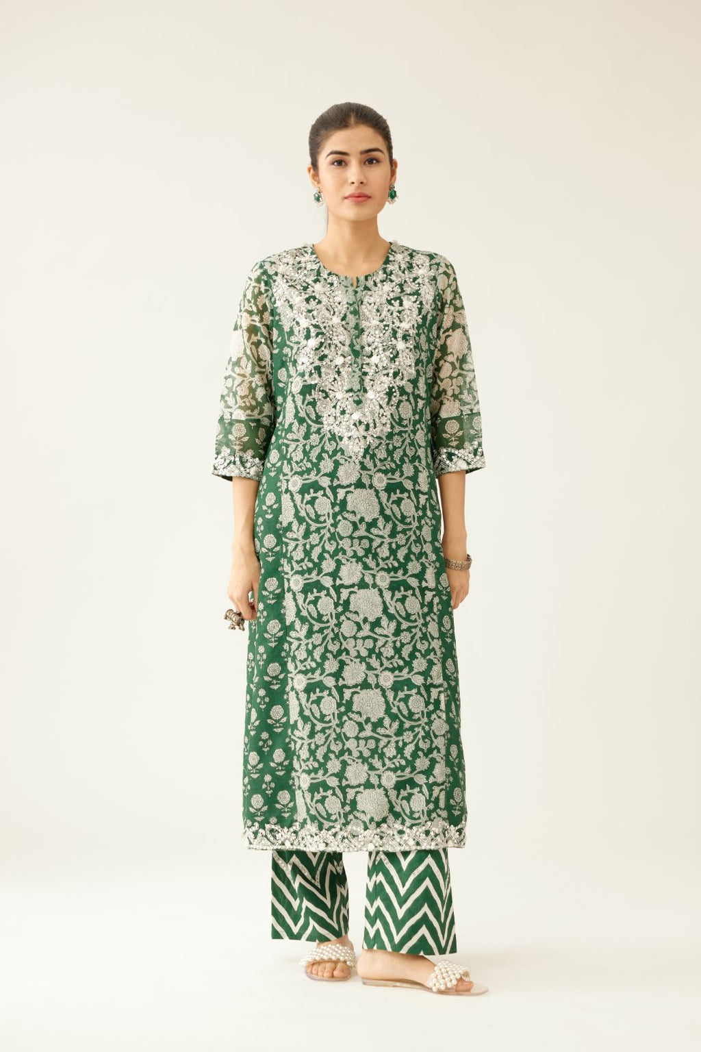 Green hand block printed kalidar straight kurta set, highlighted with sequin, tassels & bead work.