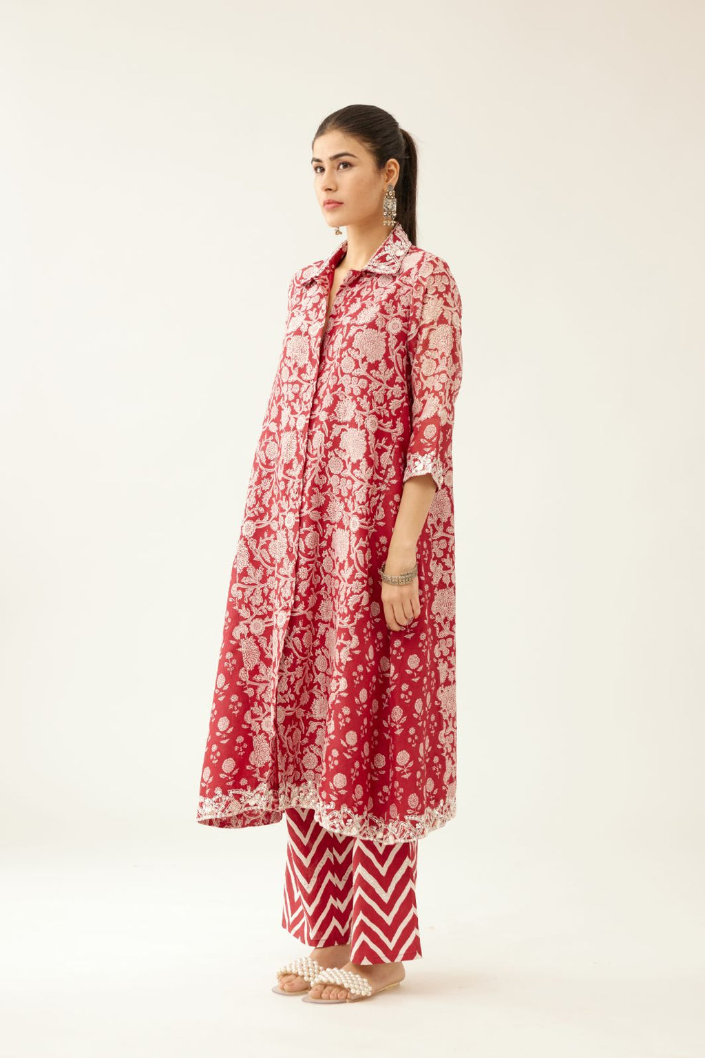 Red hand block printed A-line short kurta with sequins, tassels and bead work, paired with red & off white cotton hand block printed straight pants detailed with sequin and bead work at hem.