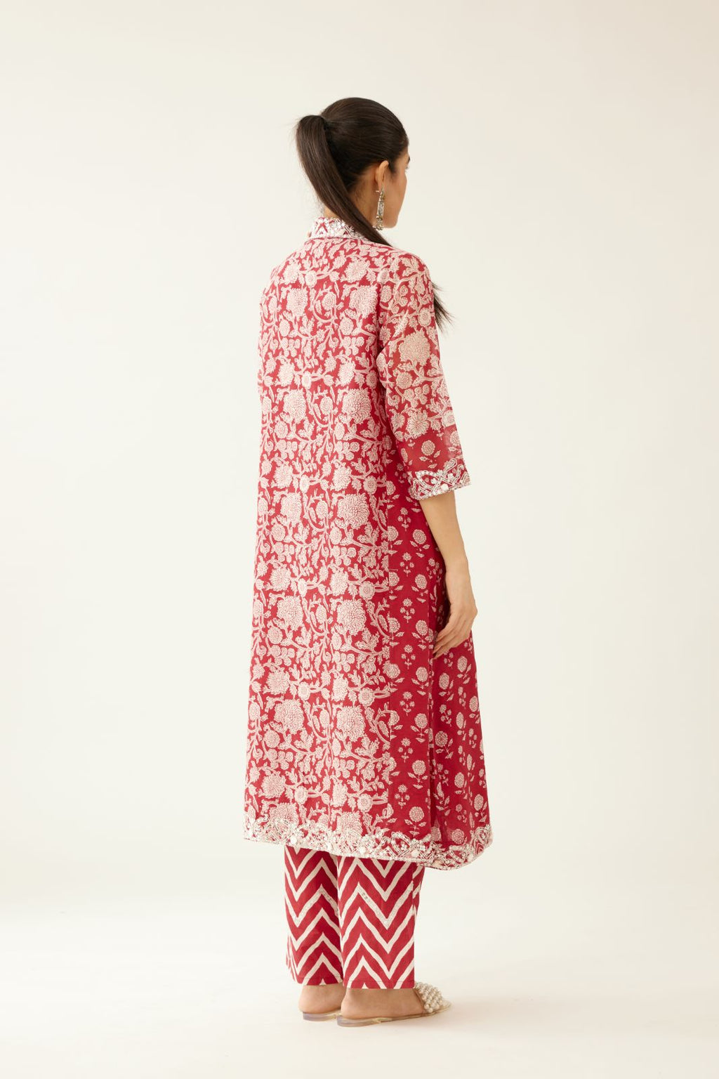 Red hand block printed A-line short kurta with sequins, tassels and bead work, paired with red & off white cotton hand block printed straight pants detailed with sequin and bead work at hem.