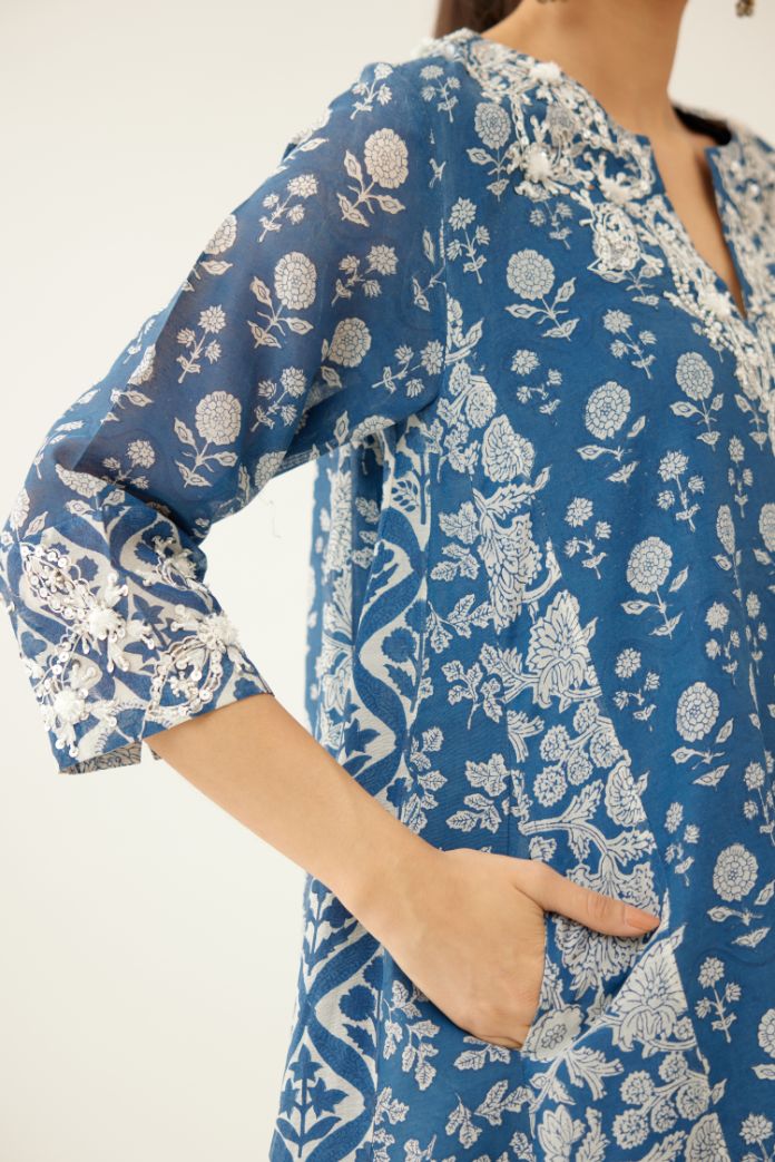 Blue hand block printed short kalidar kurta set highlighted with sequins, tassels and bead work.