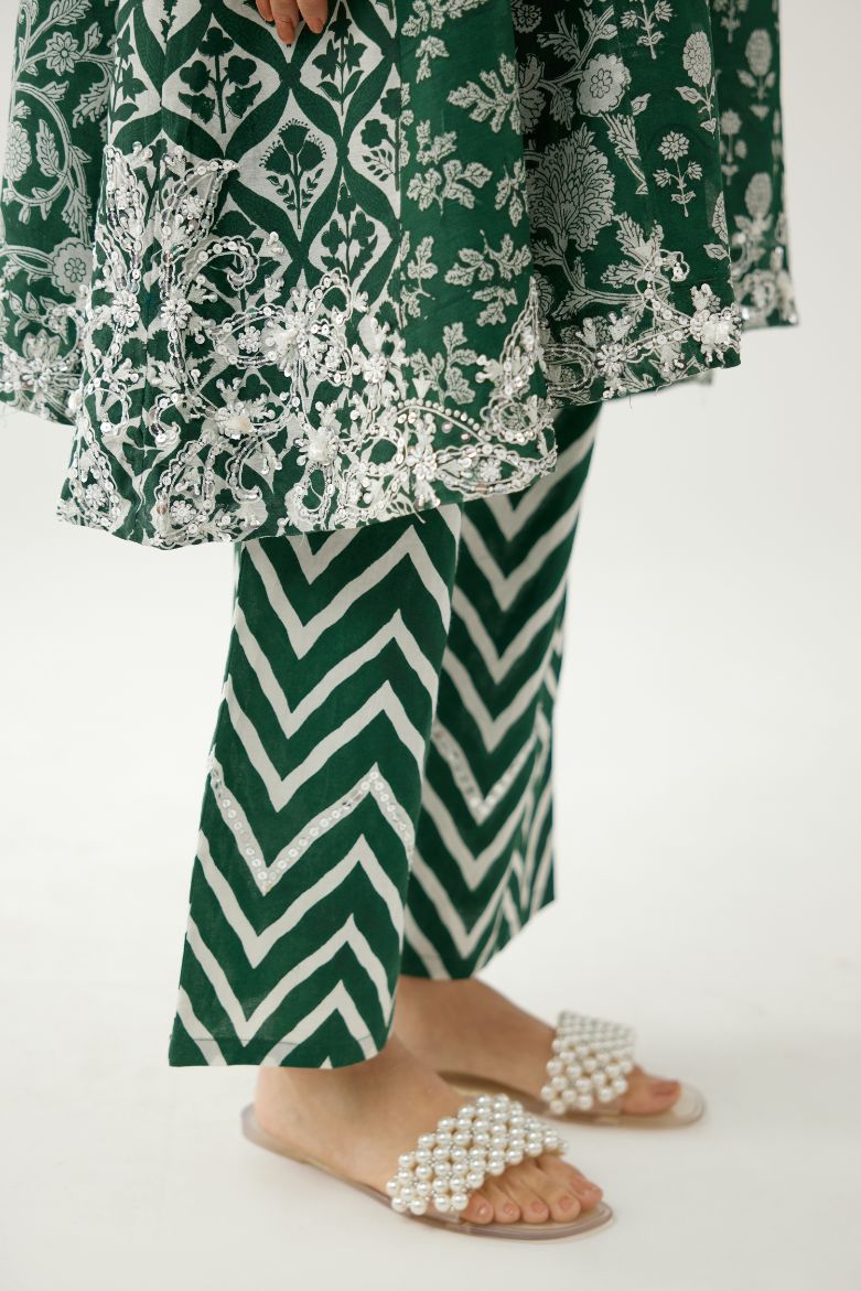 Green hand block printed short kalidar kurta set highlighted with sequins, tassels and bead work.