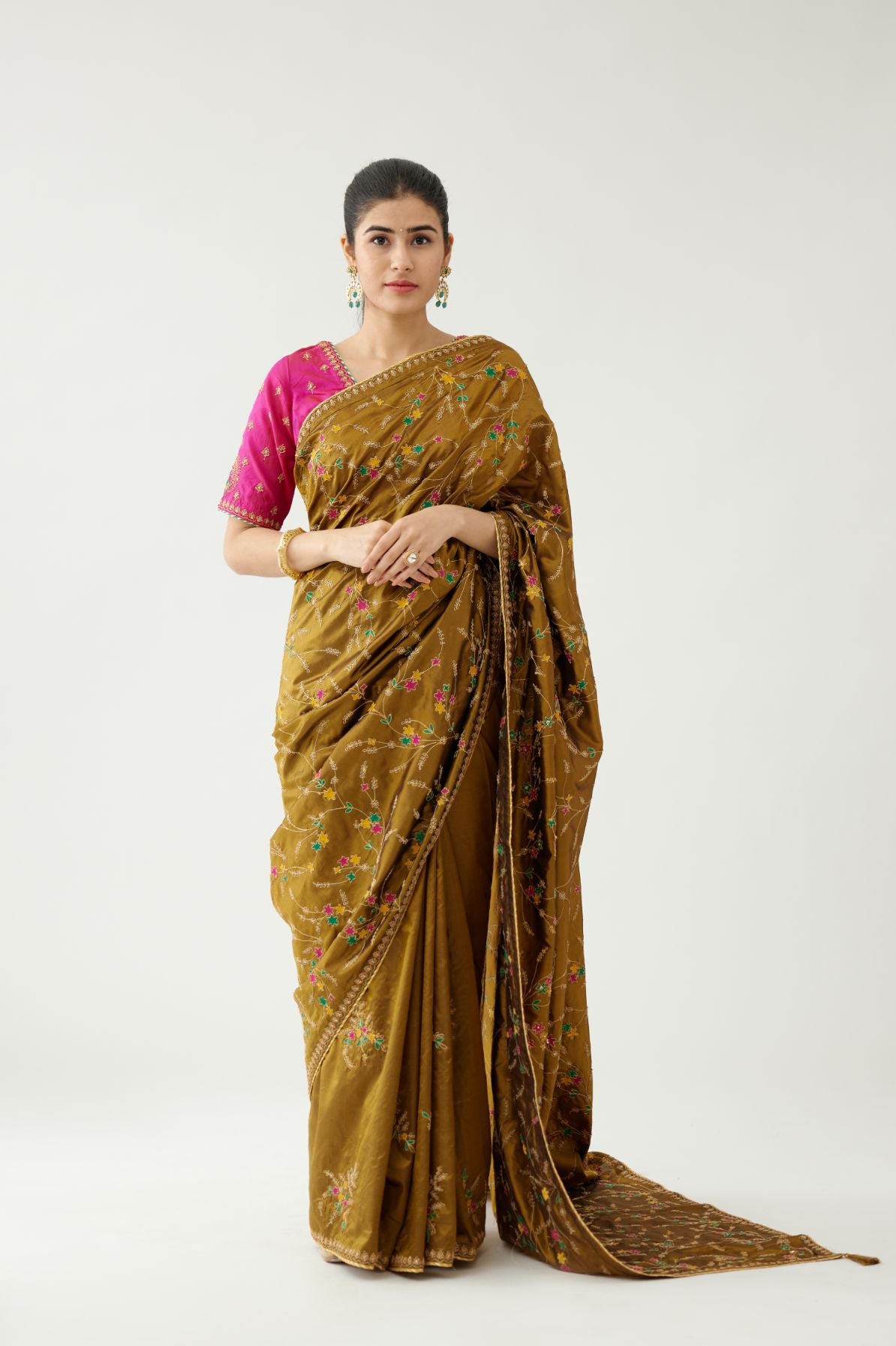 Golden olive silk saree set, detailed with all over delicate dori and silk thread embroidery work, paired with raspberry silk blouse with princess seams and all-over delicate dori and silk thread embroidered.