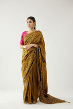 Golden olive silk saree set, detailed with all over delicate dori and silk thread embroidery work, paired with raspberry silk blouse with princess seams and all-over delicate dori and silk thread embroidered.