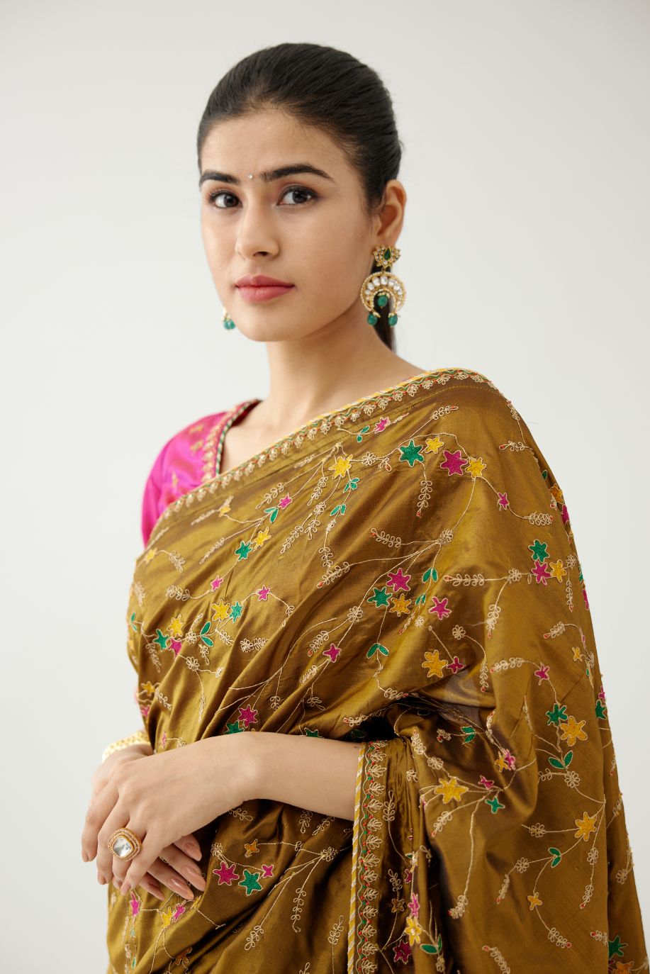 Golden olive silk saree set, detailed with all over delicate dori and silk thread embroidery work, paired with raspberry silk blouse with princess seams and all-over delicate dori and silk thread embroidered.