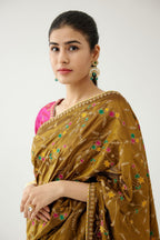 Golden olive silk saree set, detailed with all over delicate dori and silk thread embroidery work, paired with raspberry silk blouse with princess seams and all-over delicate dori and silk thread embroidered.