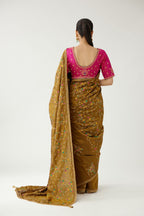 Golden olive silk saree set, detailed with all over delicate dori and silk thread embroidery work, paired with raspberry silk blouse with princess seams and all-over delicate dori and silk thread embroidered.