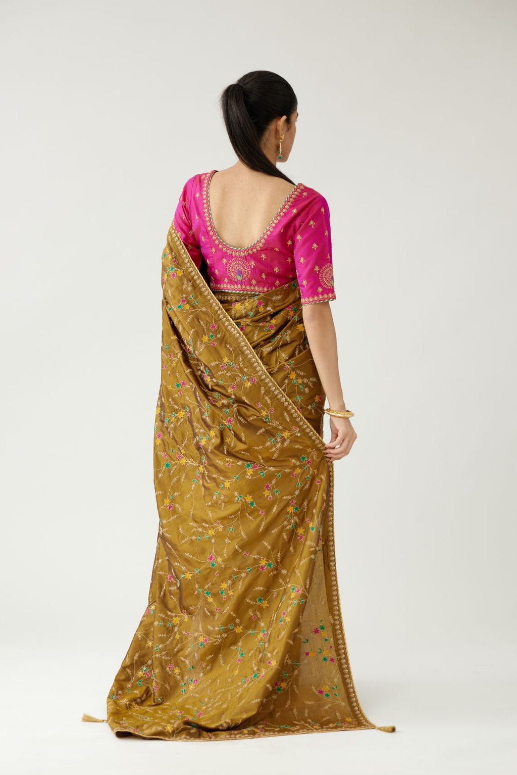 Golden olive silk saree set, detailed with all over delicate dori and silk thread embroidery work, paired with raspberry silk blouse with princess seams and all-over delicate dori and silk thread embroidered.