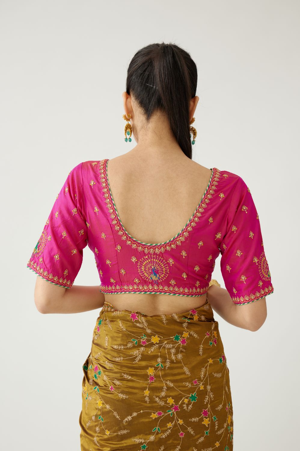 Golden olive silk saree set, detailed with all over delicate dori and silk thread embroidery work, paired with raspberry silk blouse with princess seams and all-over delicate dori and silk thread embroidered.