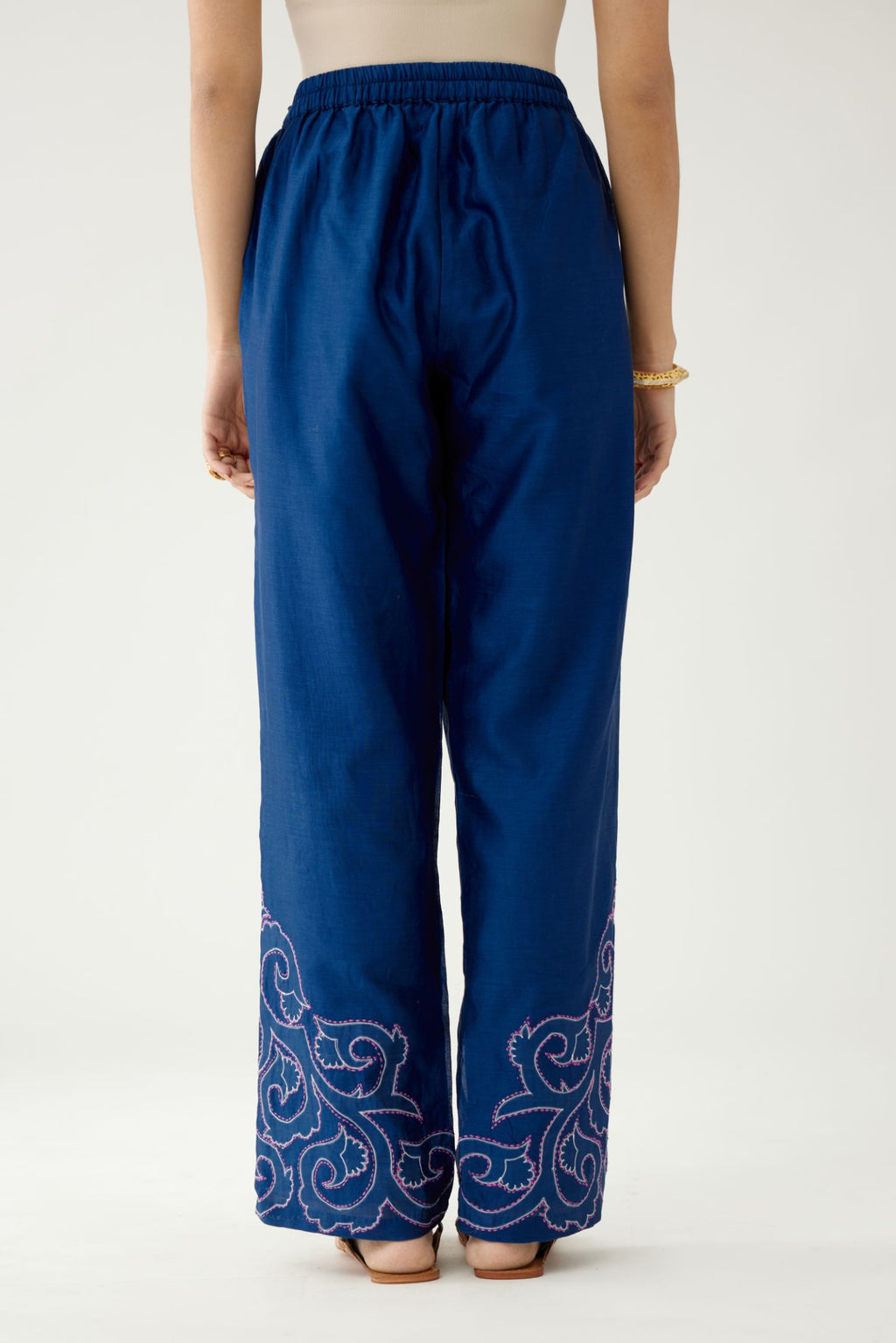 Blue silk chanderi straight pants with cotton appliqué jaal work at reverse side, highlighted with kantha work in front side at bottom hem.