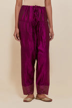 Purple silk salwar with hand-embroidered gold sequin work in a broad border at the hem.