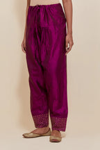 Purple silk salwar with hand-embroidered gold sequin work in a broad border at the hem.
