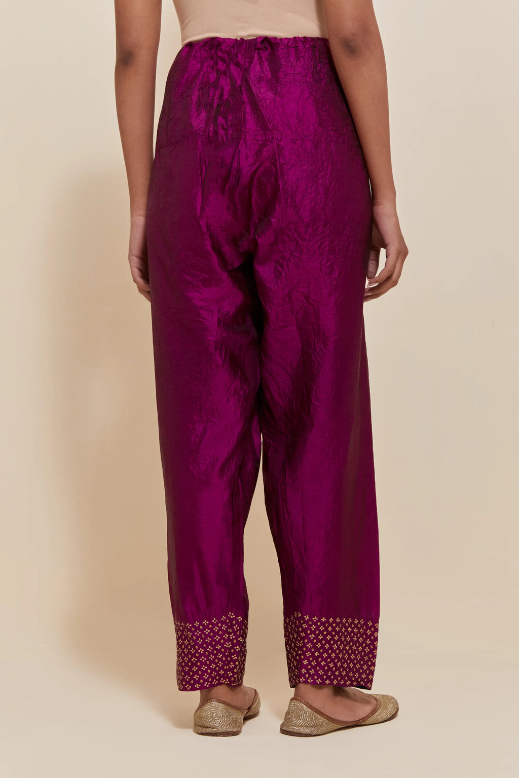 Purple silk salwar with hand-embroidered gold sequin work in a broad border at the hem.