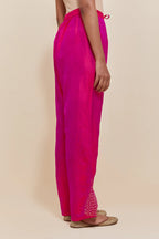 Fuchsia silk salwar with hand-embroidered gold sequin work in a broad border at the hem.