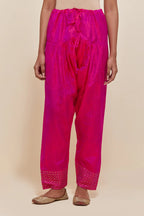 Fuchsia silk salwar with hand-embroidered gold sequin work in a broad border at the hem.