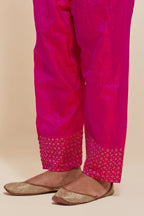 Fuchsia silk salwar with hand-embroidered gold sequin work in a broad border at the hem.