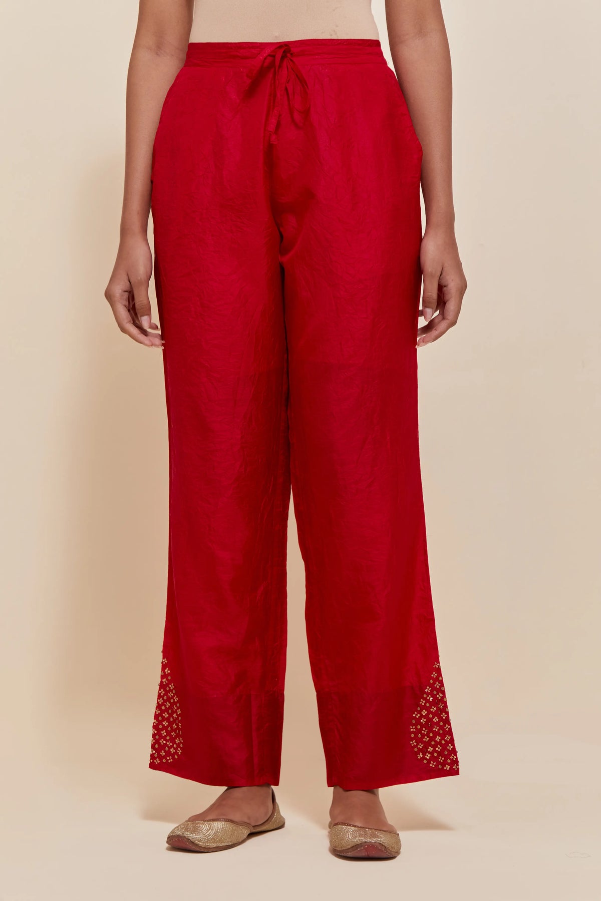 Red Silk pants with hand embroidered leaf motifs with delicate sequins work at hem.