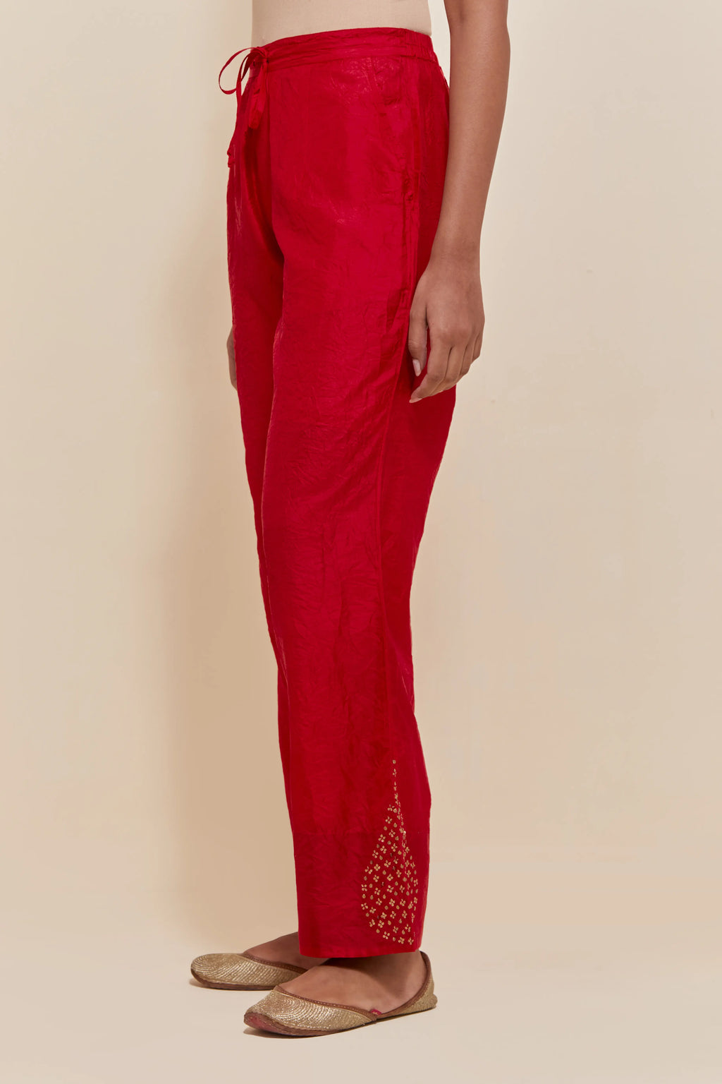Red Silk pants with hand embroidered leaf motifs with delicate sequins work at hem.